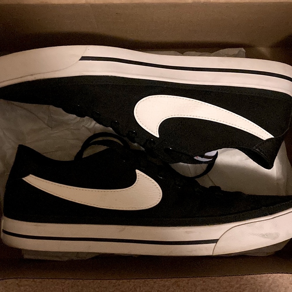 Nike sports shoes.  Bought wrong size and wore them once outside.